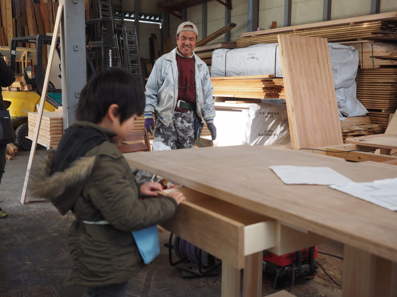「そのテーブルはおじさんがつくったんだ！」と益子大工さん。「すごい！」と驚くこうすけ君。