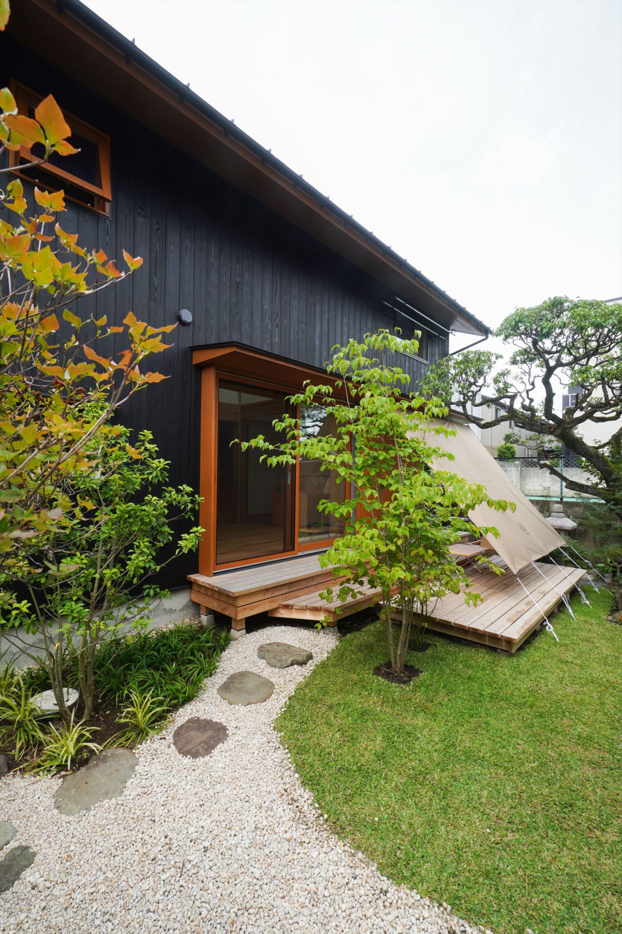 下のウッドデッキはご主人作。小川テントで購入したタープを張って夏場も心地よい空間に。