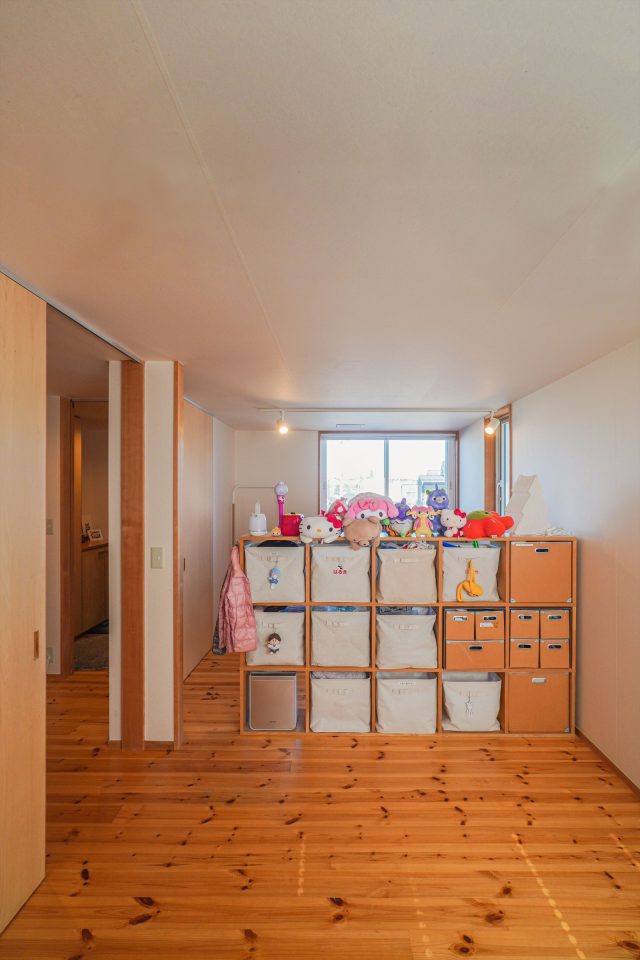 収納家具で緩やかに仕切られた子ども部屋。