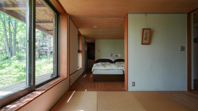 1階の寝室と畳の客間。普段は間の扉を開けて一室空間に。