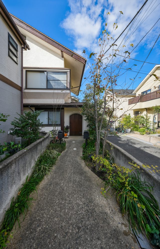 低い重心に大きな切妻屋根が伝統的な和風建築の趣です。豊かな緑に囲まれた小川の流れのようなアプローチが迎えてくれます。